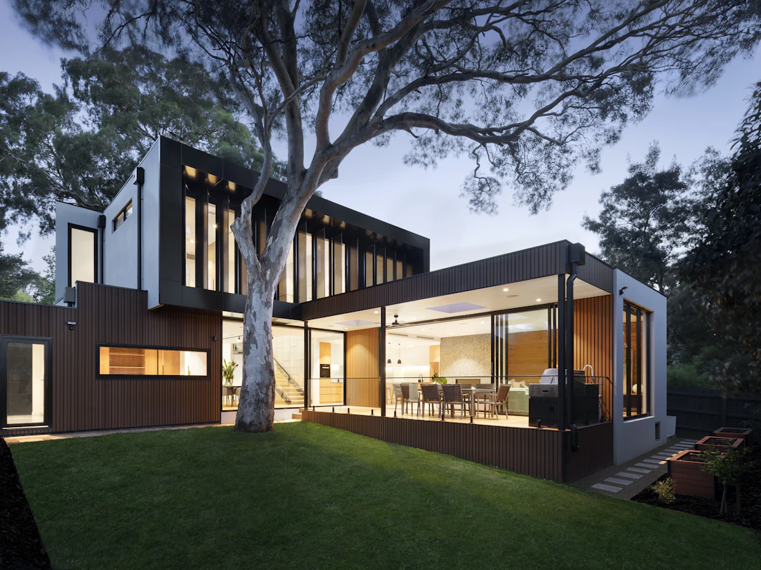 A modern home with large windows at dusk